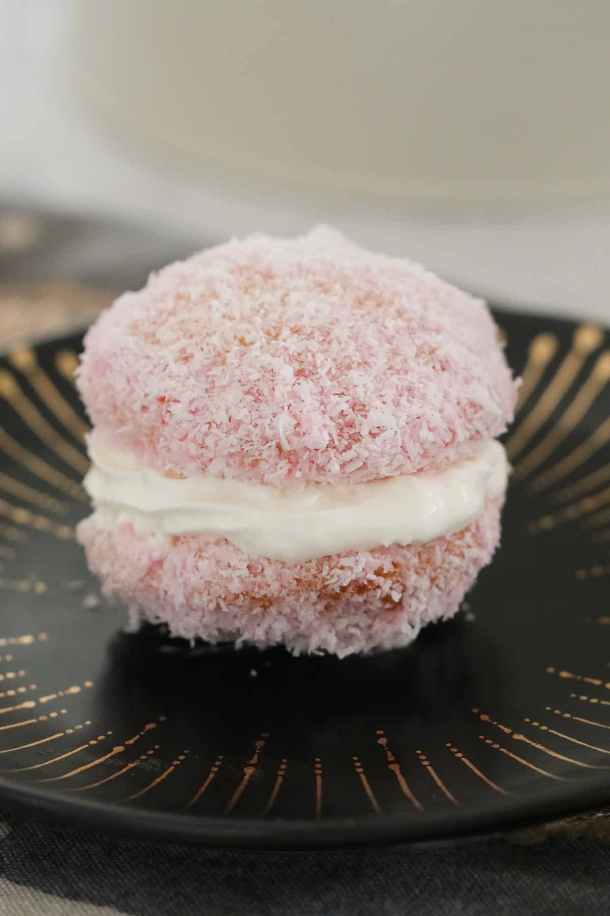 A jelly cake coated in coconut and filled with whipped cream.