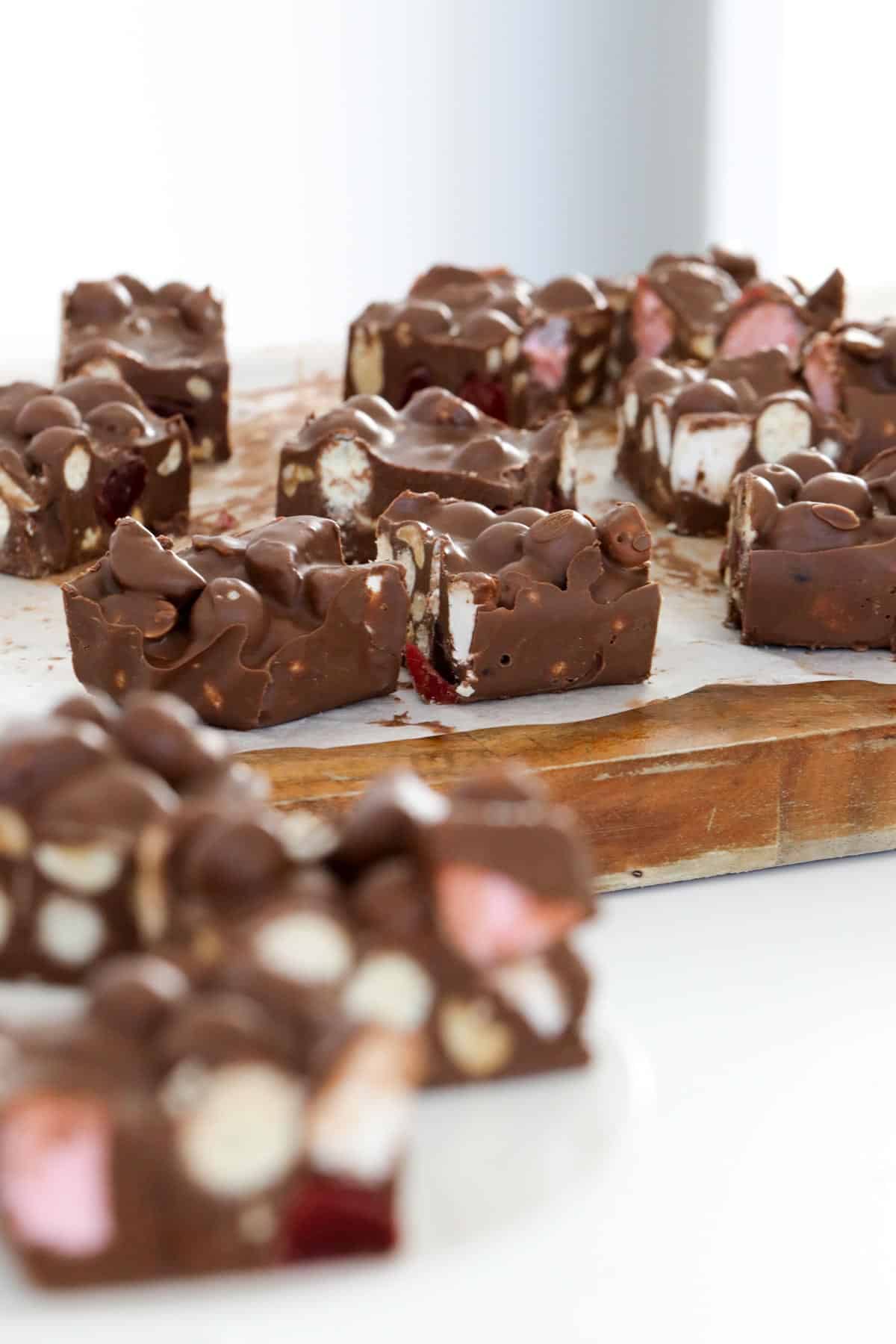 Pieces of chocolate rocky road on a wooden board.