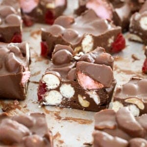 Malteser rocky road cut into pieces on a chopping board.