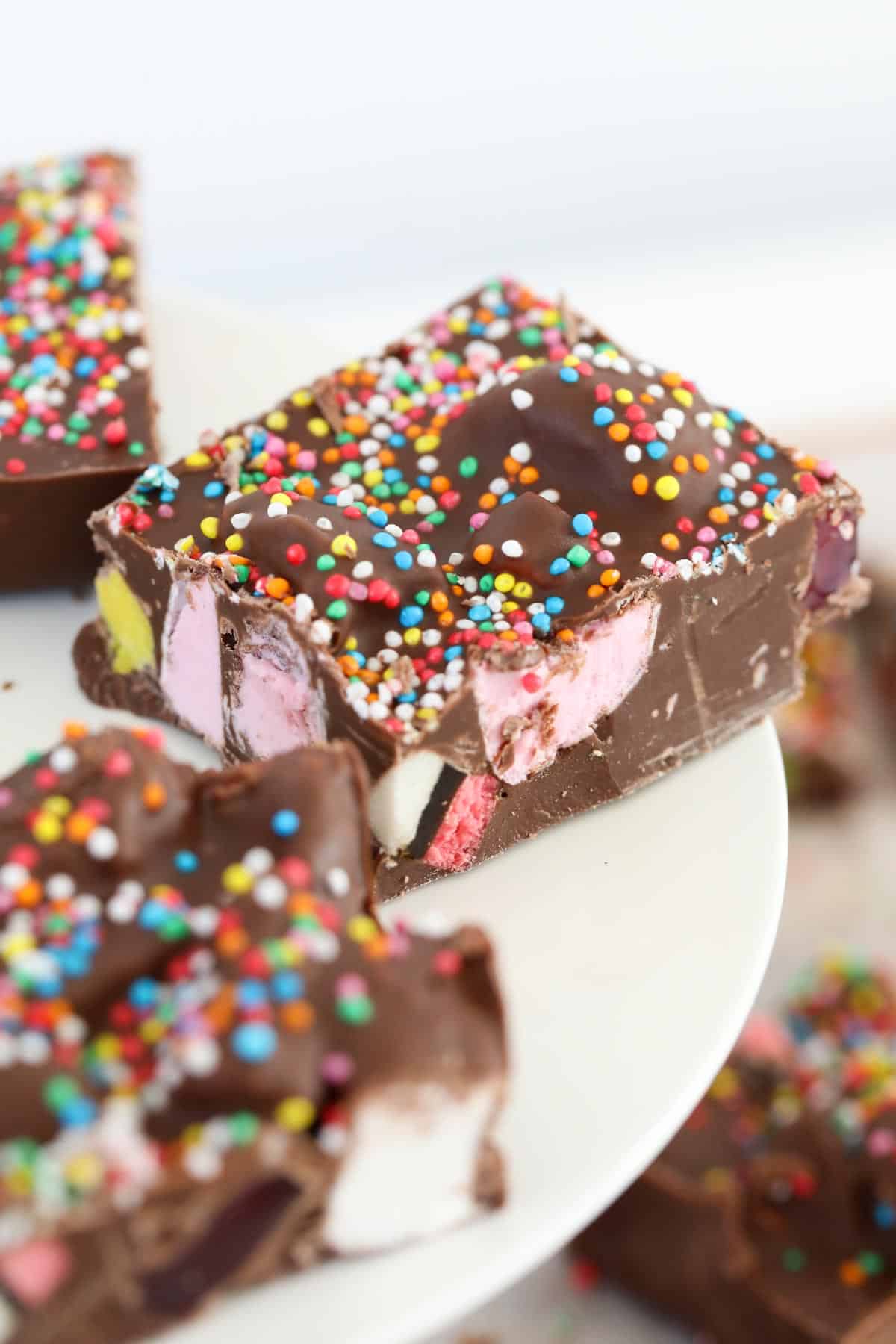 Pieces of rocky road with marshmallows, licorice allsorts and sprinkles.