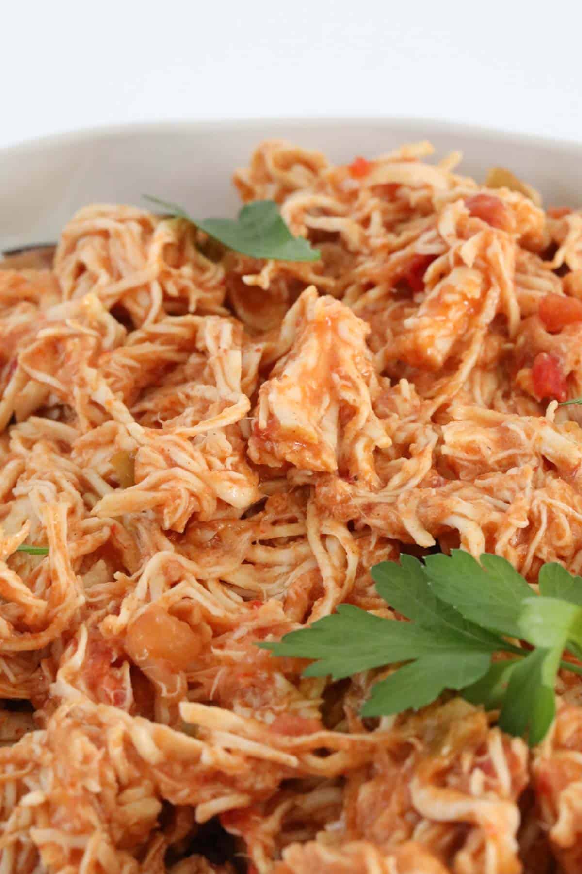 Finely shredded chicken meat in a tomato based sauce.