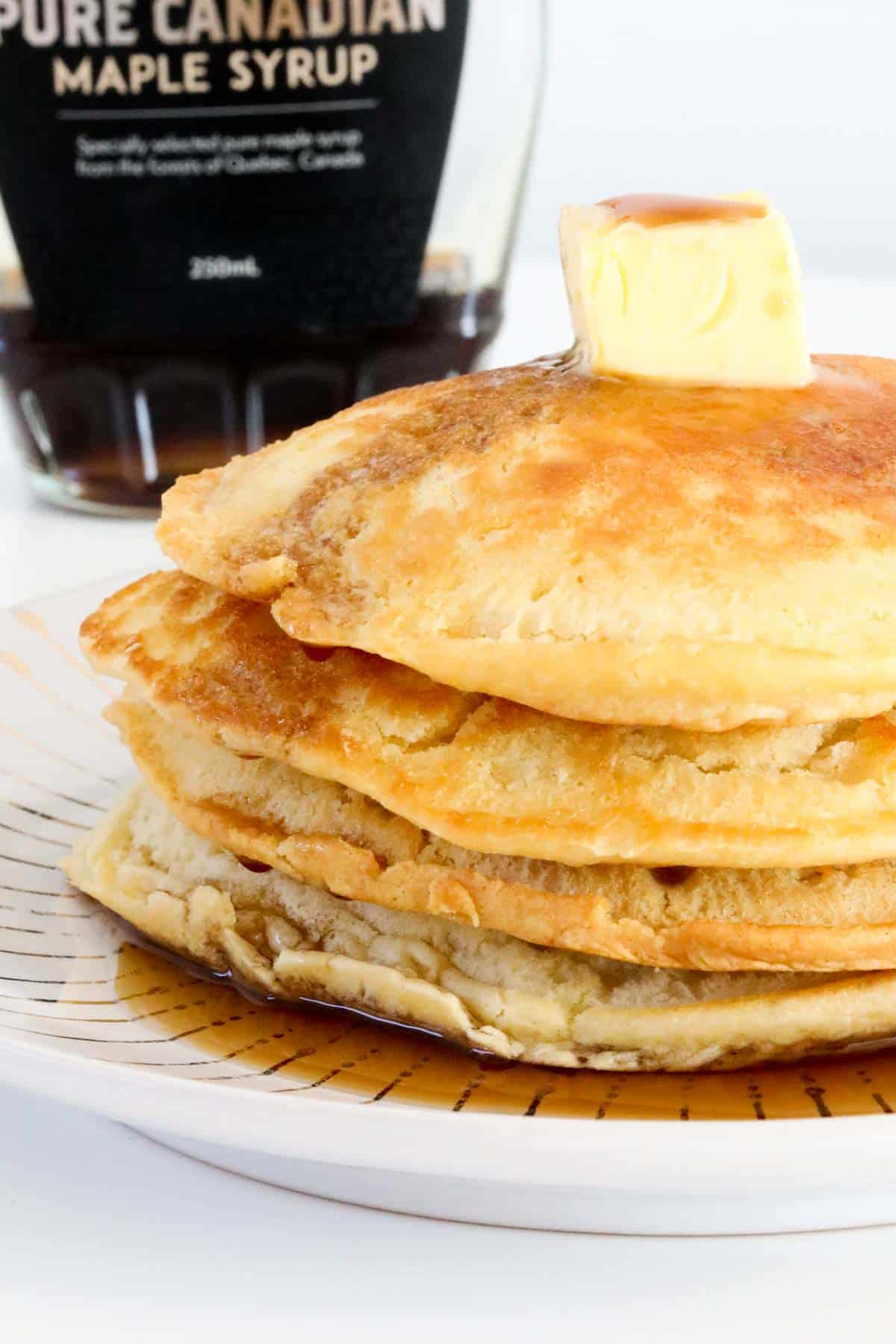 Butter melting on top of a stack of pancakes.