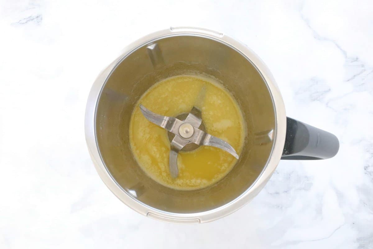 Melted butter in a stainless jug.