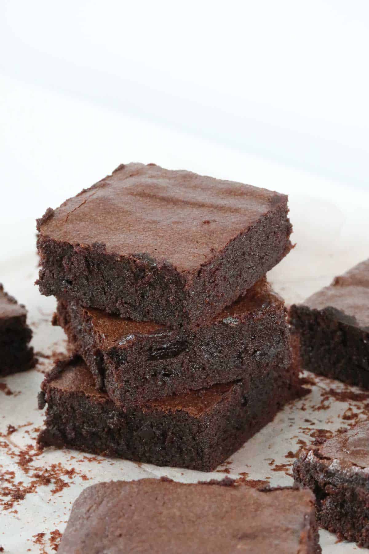 A stack of three pieces of chocolate brownie.