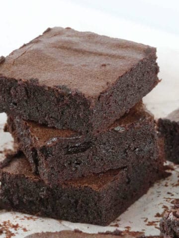 A stack of 3 pieces of fudgy chocolate brownies.