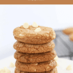 A stack of golden cookiesstudded with white chocolate chips.