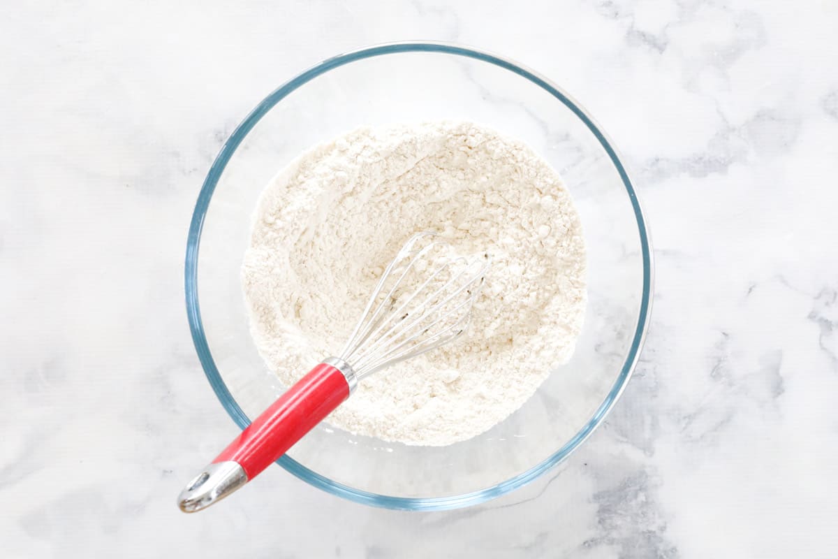 Sifted flour and baking soda in a glass bowl