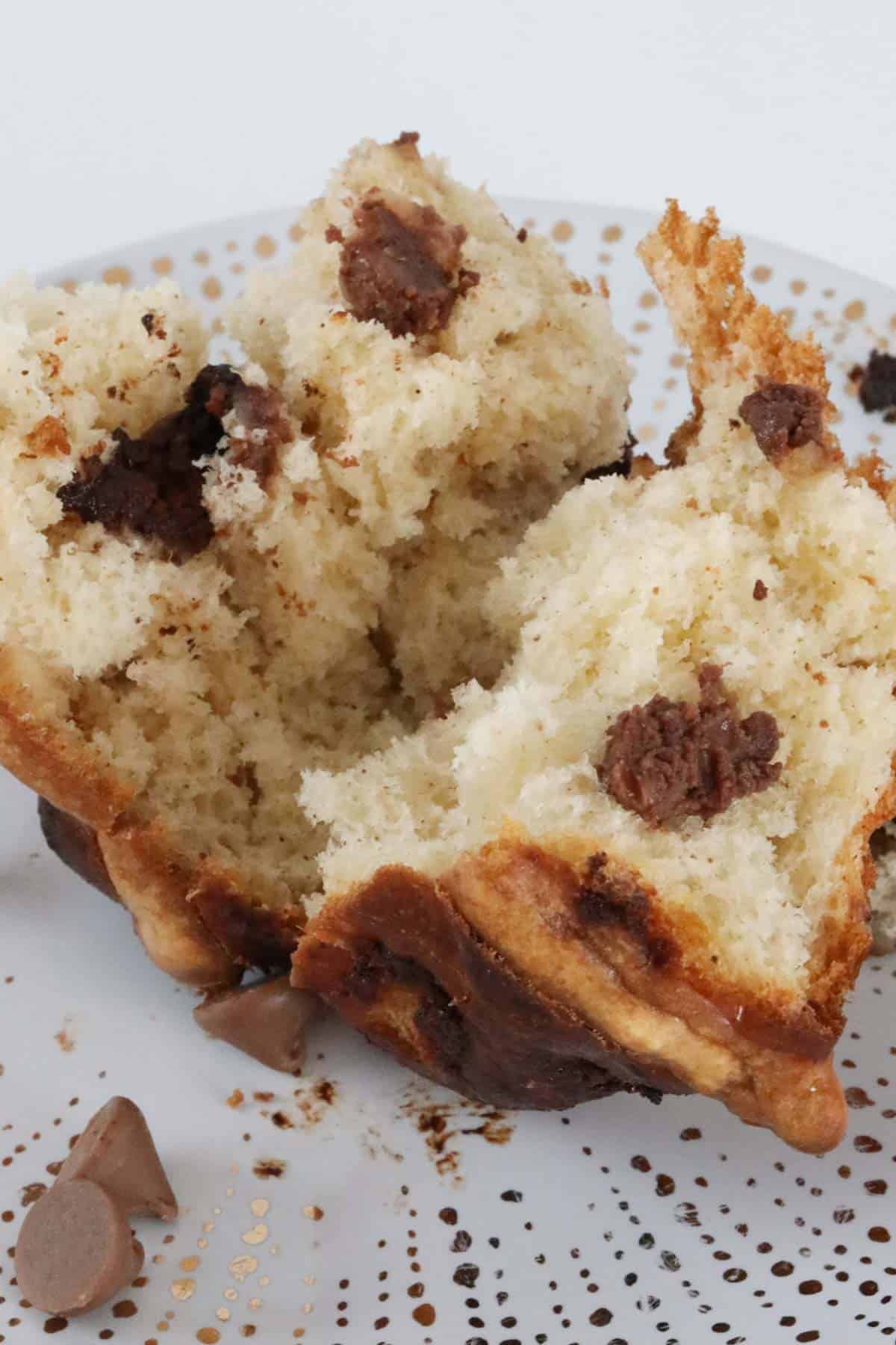 A fluffy sweet bread roll with chocolate chips split in half.
