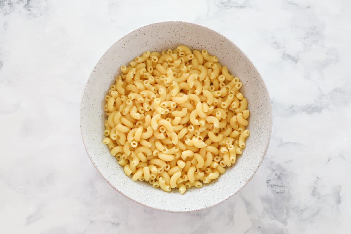Cooked and drained macaroni pasta in a white bowl