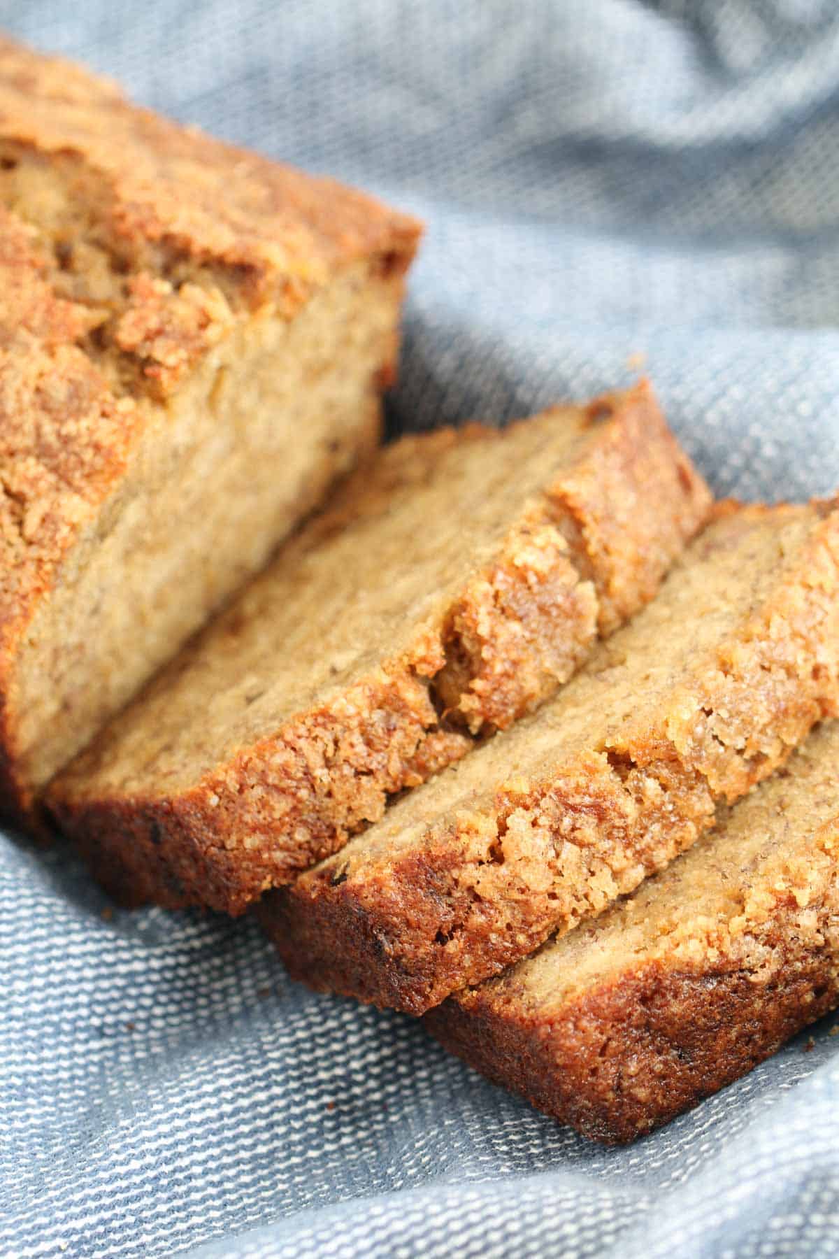 Slices of moist banana bread with a crunchy sugar topping.