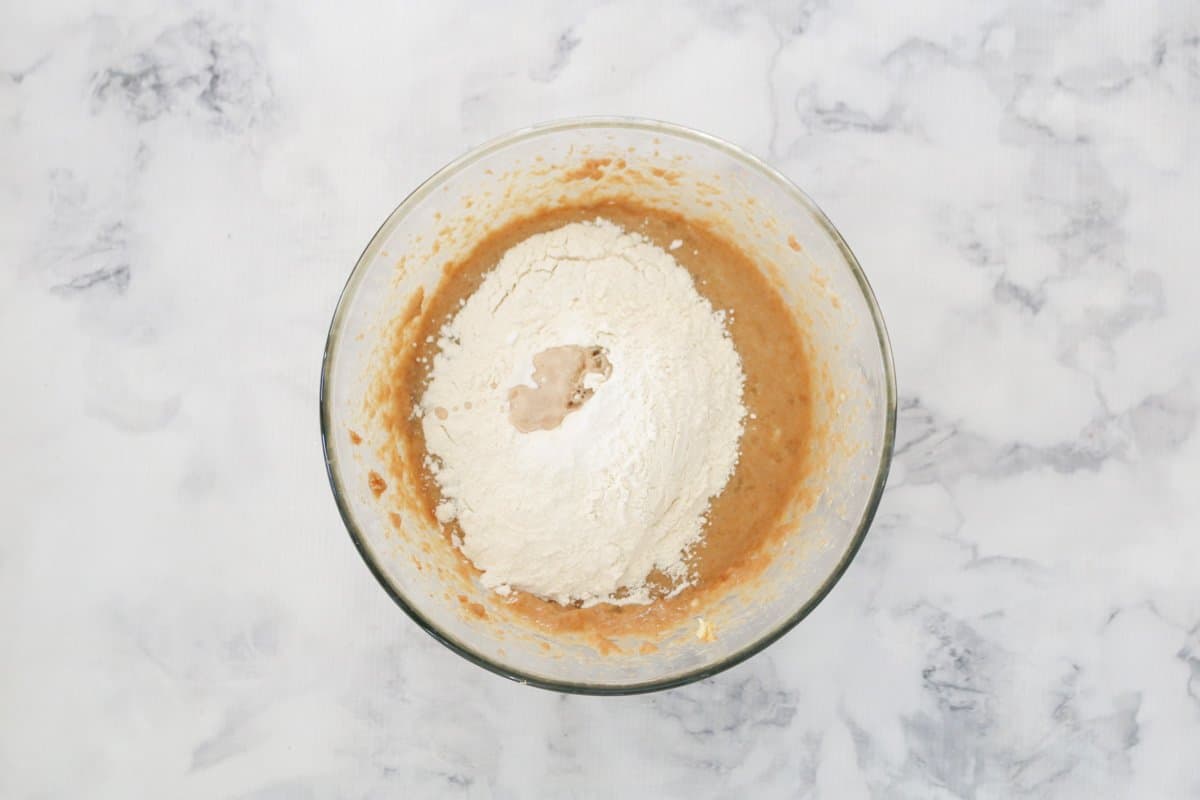 Flour on top of banana cake batter.