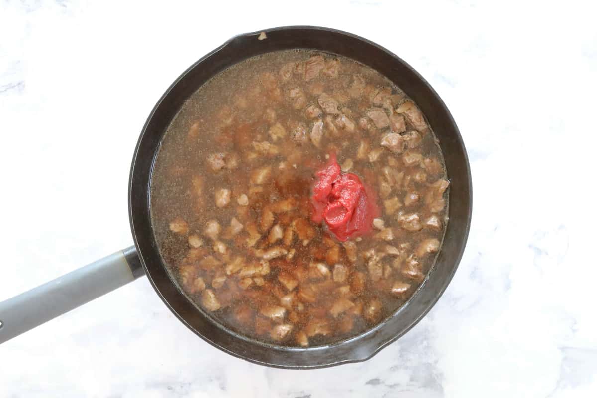 Beef and pie filling ingredients in a frying pan.