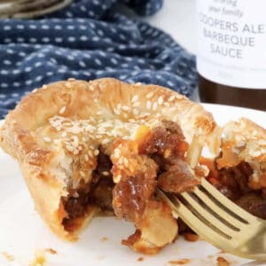 A beef party pie cut in half.
