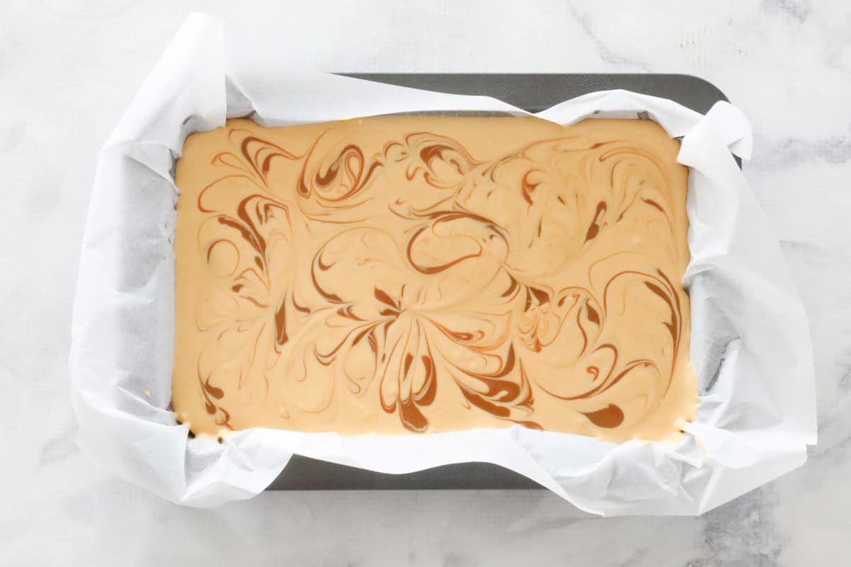 Swirls of caramel through a cheesecake slice.