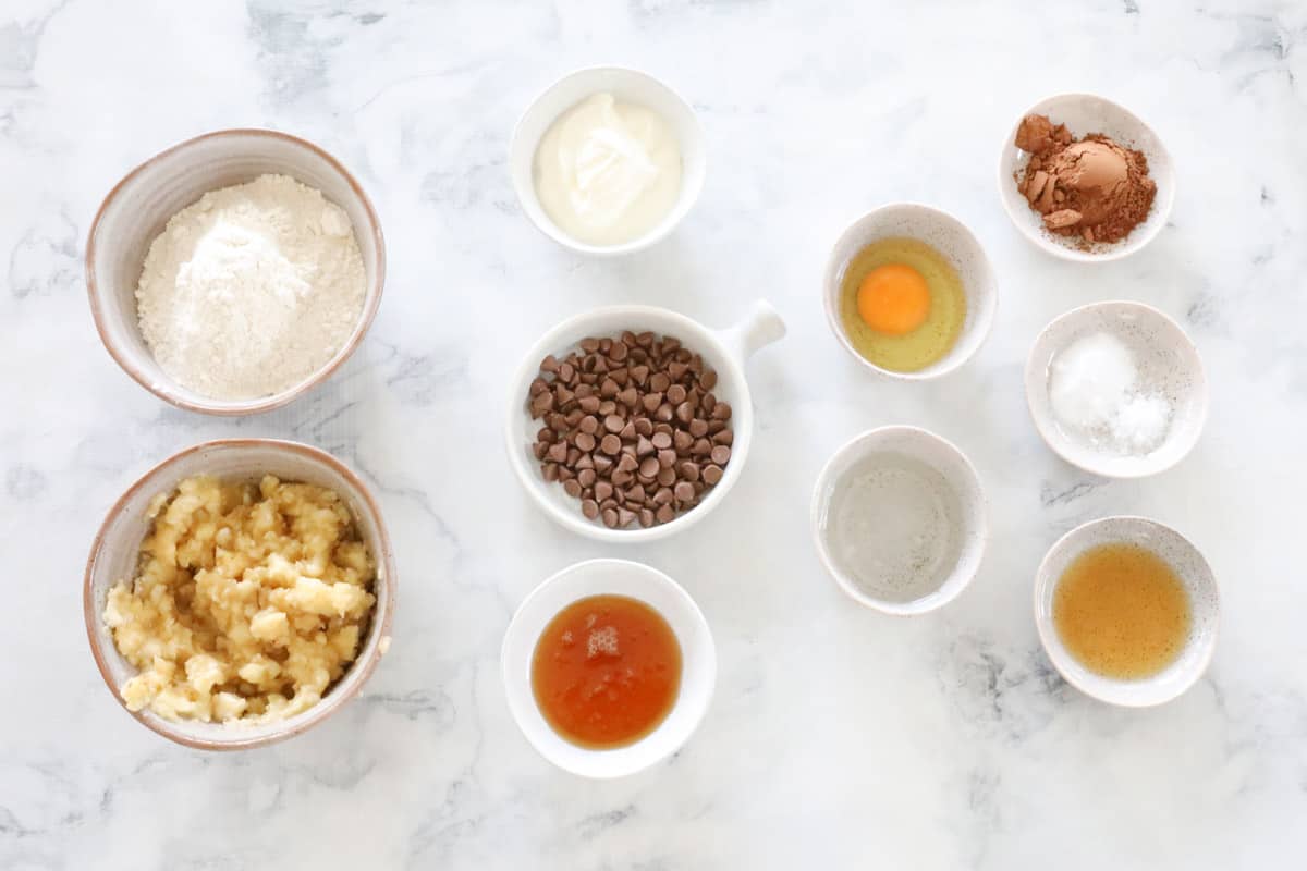 The ingredients set out in individual bowls on a marble bench top.
