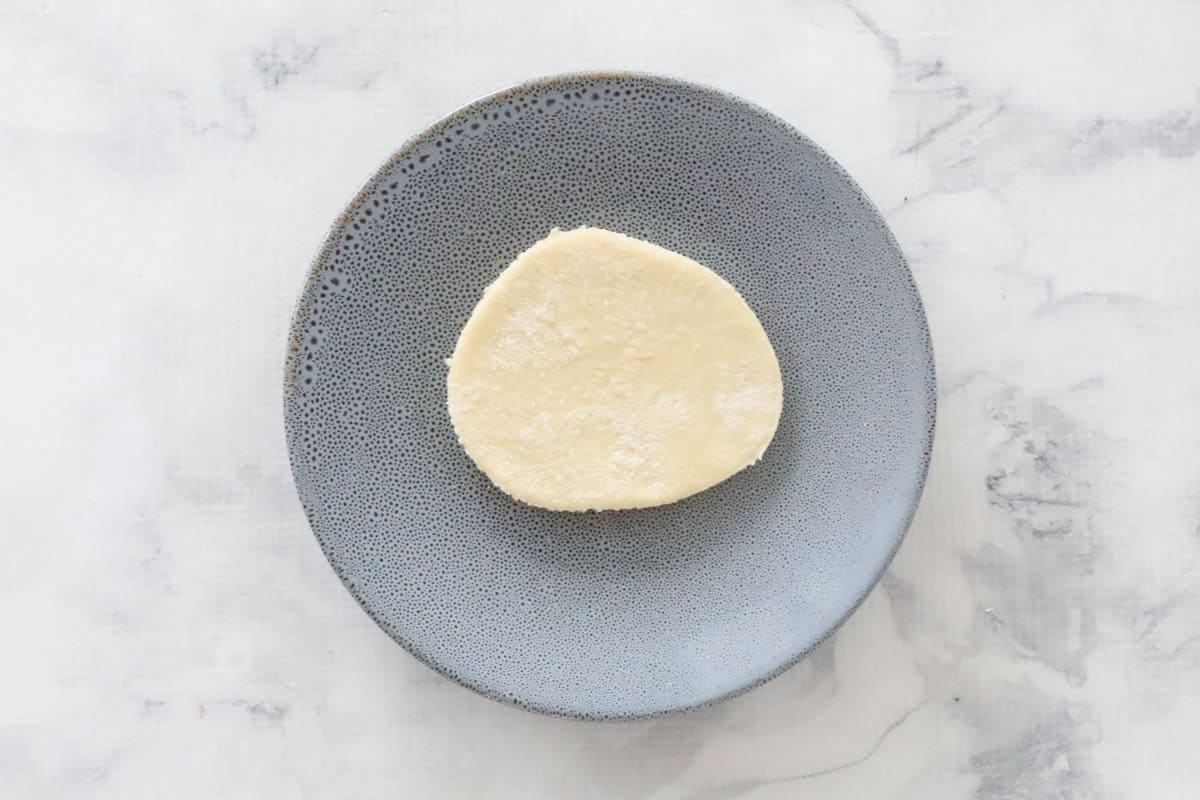 A circle of dough on a plate