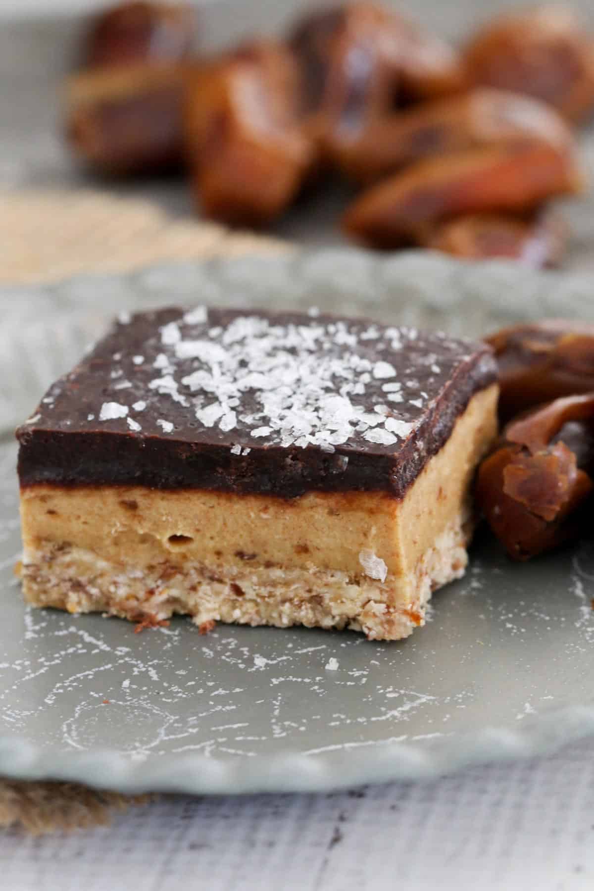 Vegan caramel slice topped with salt flakes on a plate