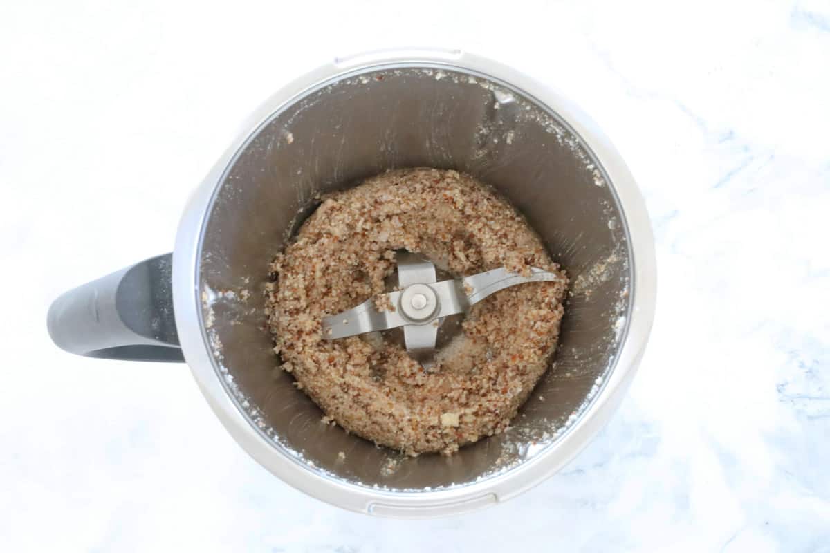 A blended almond and date mixture in a thermomix