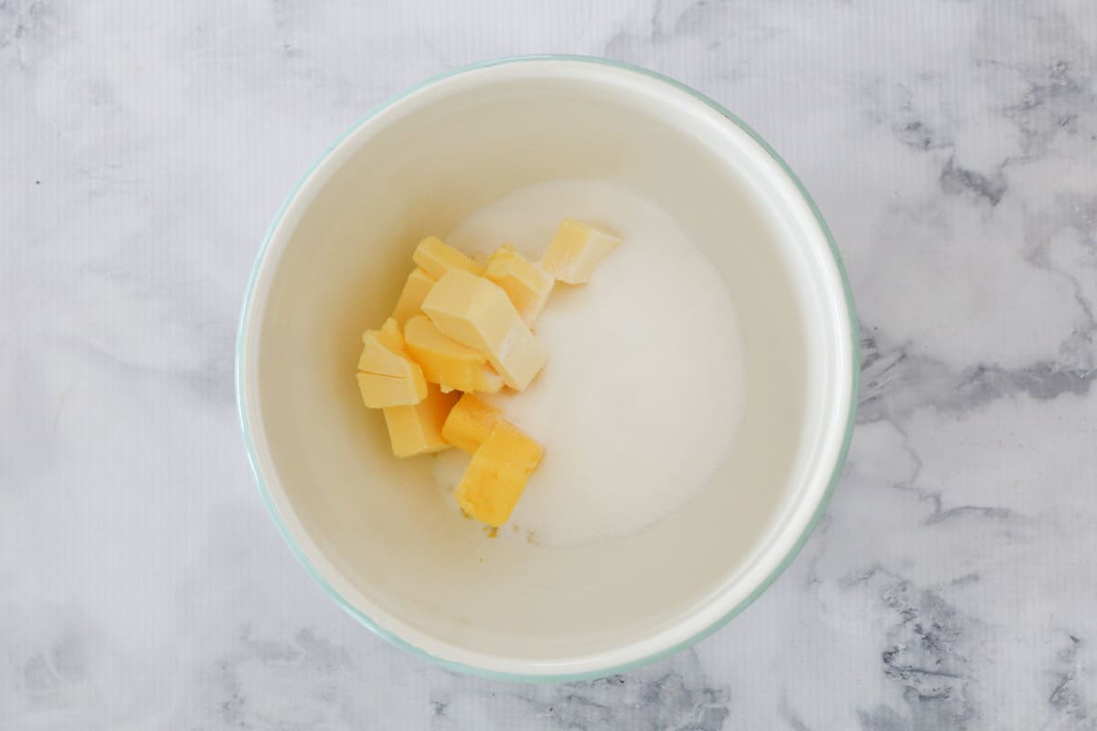 Butter, sugar and lemon zest placed in a bowl.