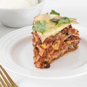 A layered Mexican lasagne made with tortillas and taco beef mince.