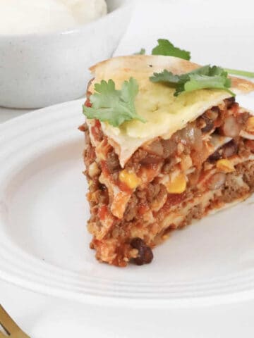 A layered Mexican lasagne made with tortillas and taco beef mince.