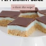 Squares of a peppermint slice topped with a chocolate layer, served on a cake stand.