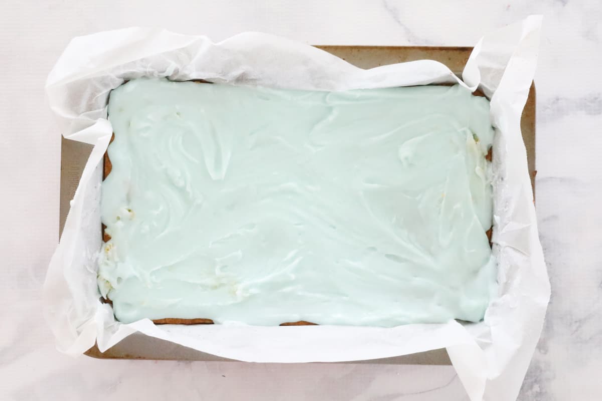 Pale green layer spread over the baked base in slice tin.