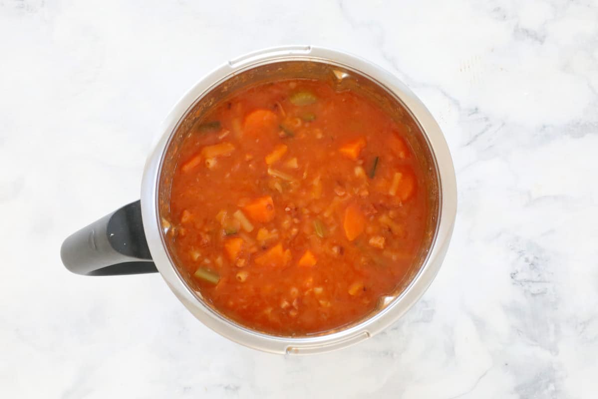 A tomato vegetable soup in a Thermomix bowl.