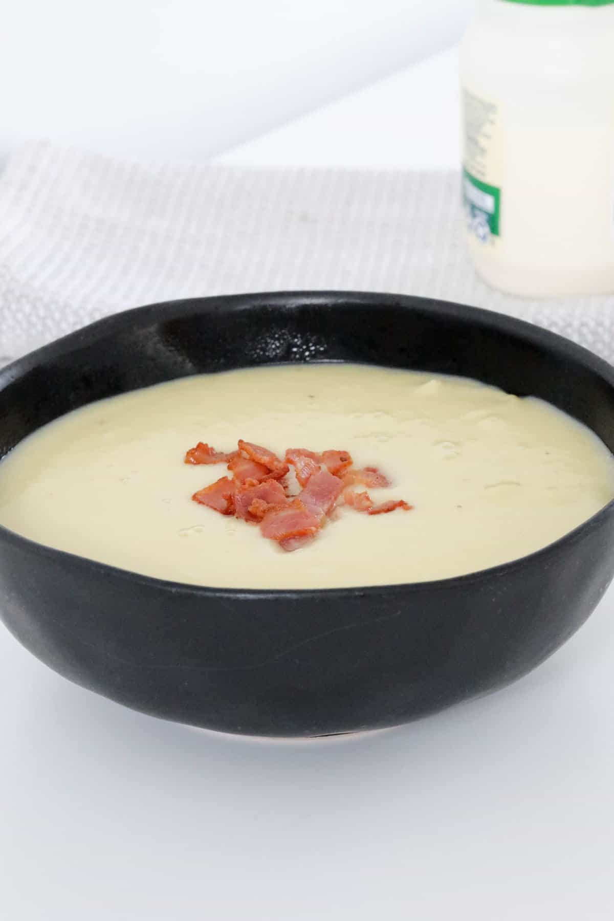 A bowl of creamy potato and bacon soup.