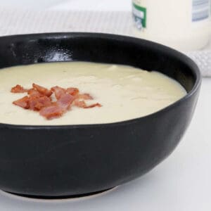 A bowl of creamy potato and bacon soup.