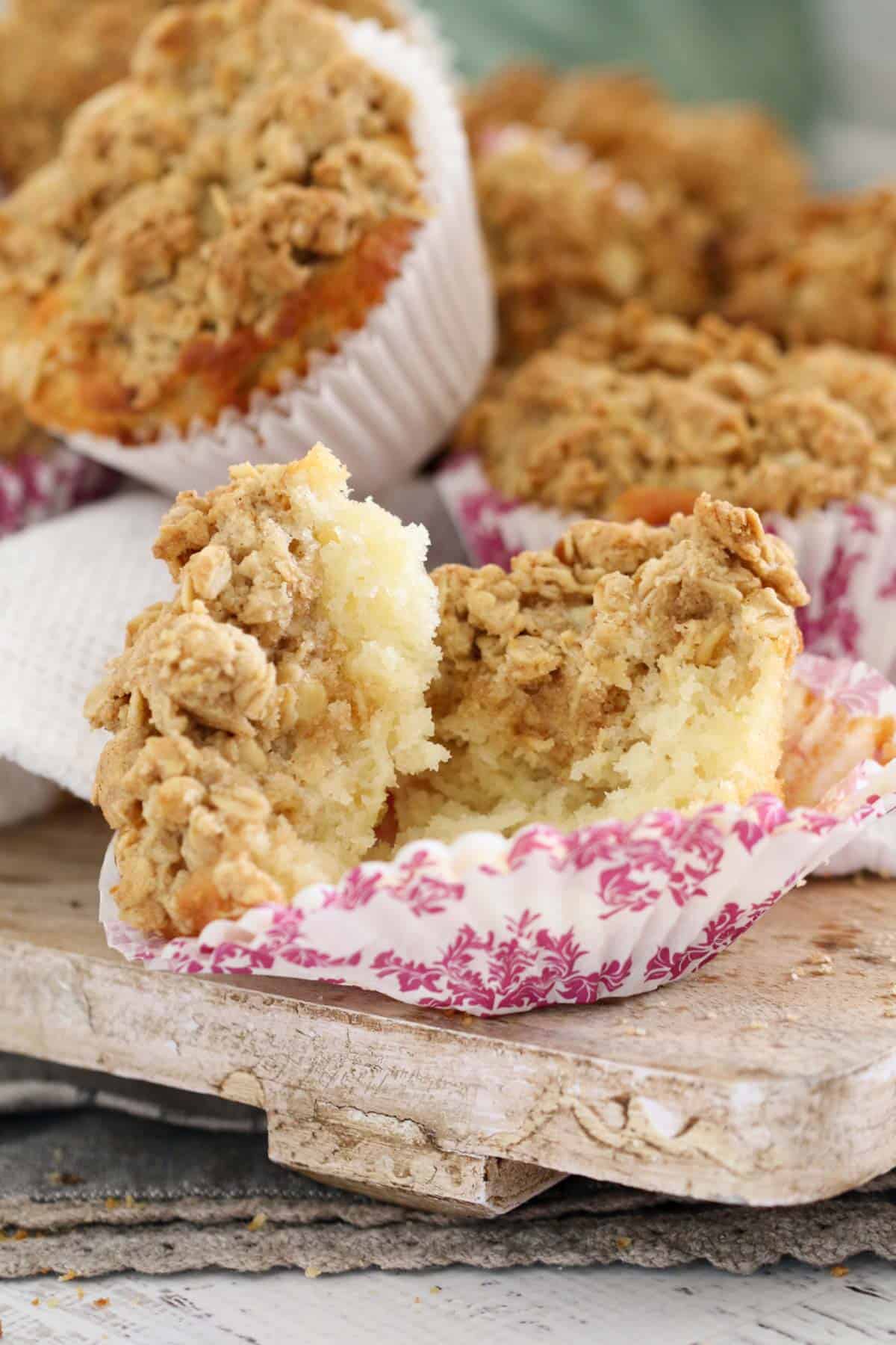An apple muffin split in half to show the texture inside.