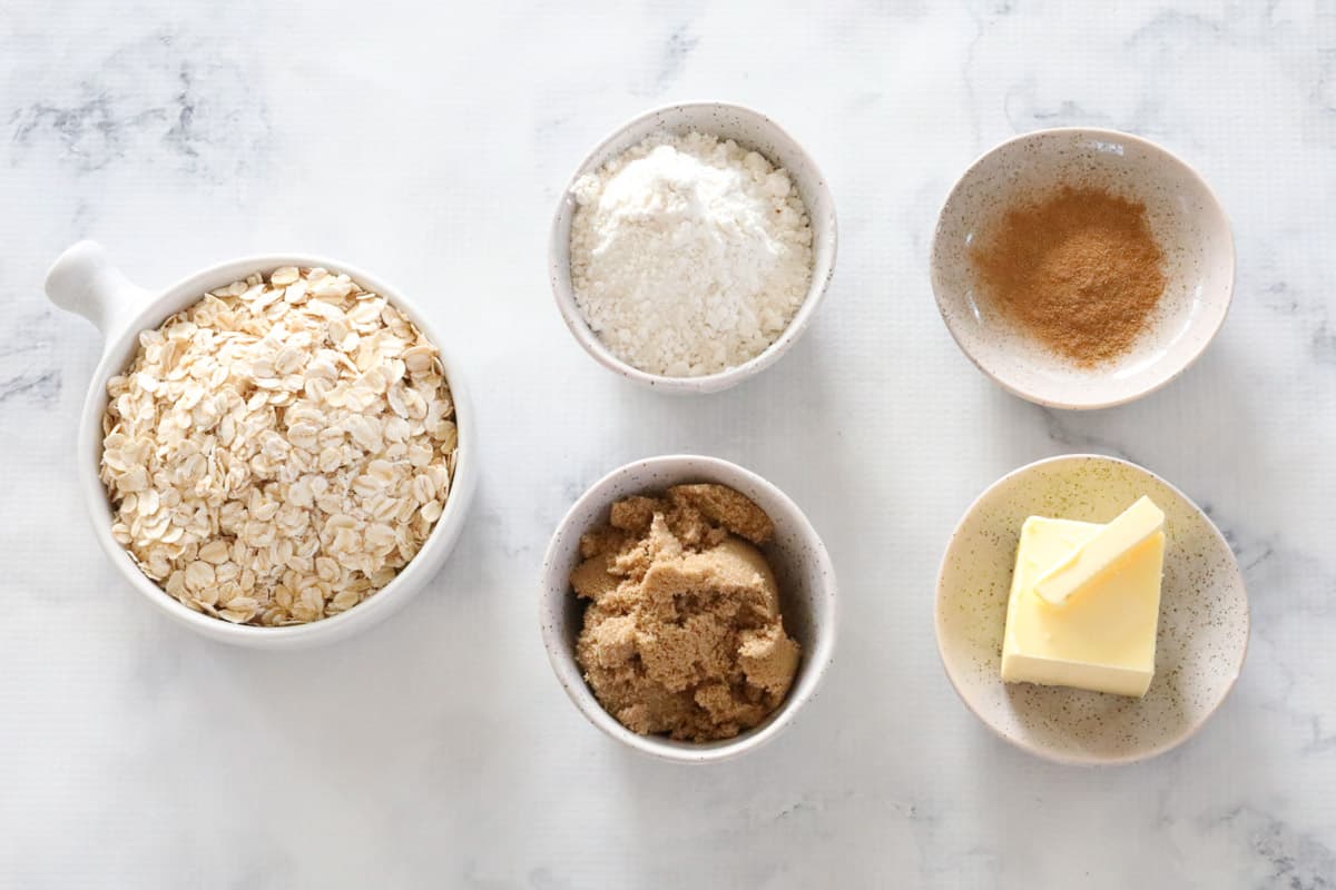 Ingredients for crunchy crumble topping in individual bowls.