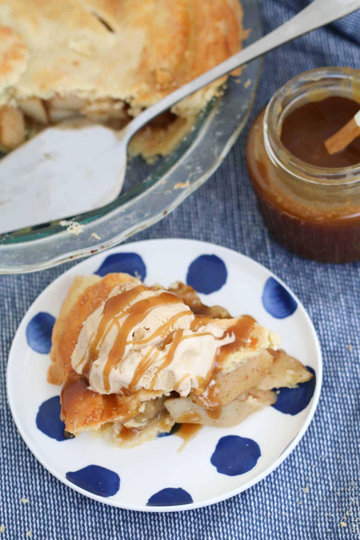 Caramel sauce drizzled over a slice of dessert pie with ice cream.