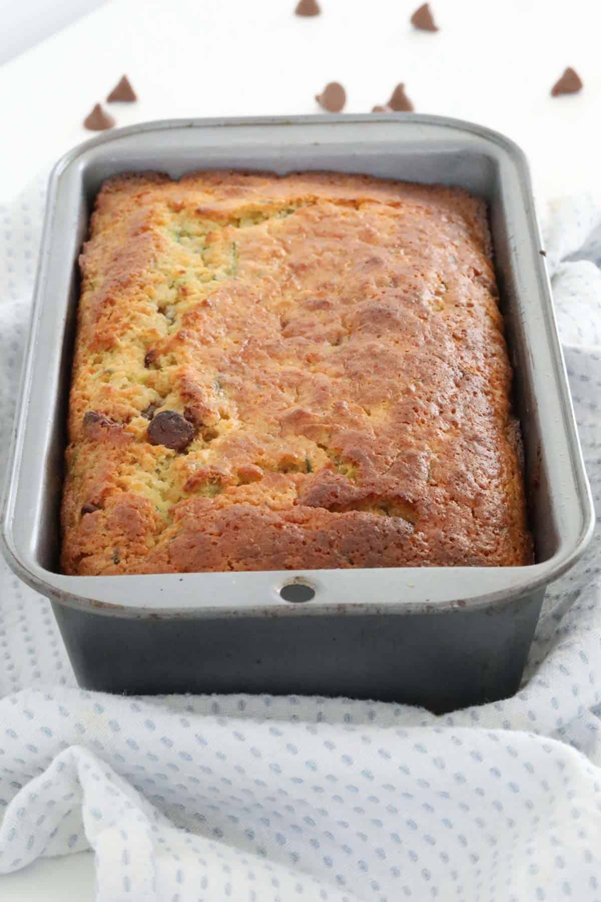 Finished zucchini bread in a loaf tin.
