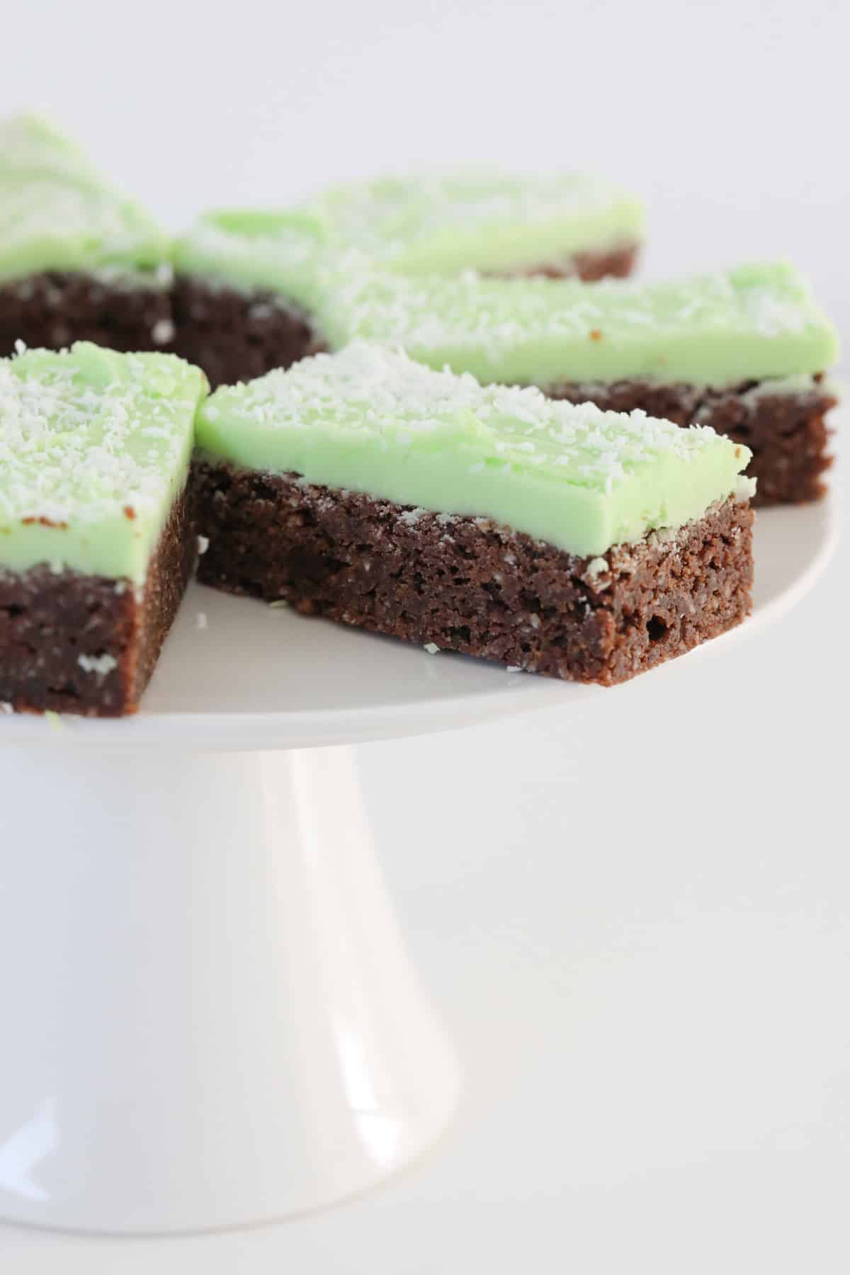 Pieces of mint slice on a white cake stand.