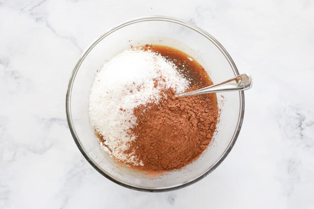 Plain flour, self raising flour, and cocoa sifted into a bowl.
