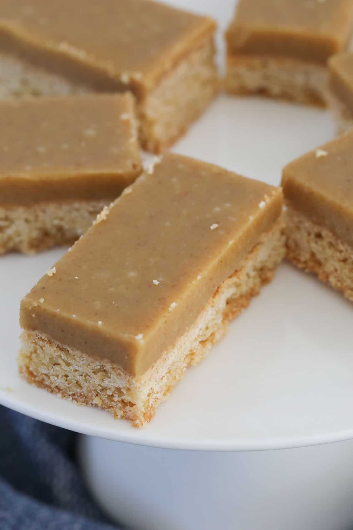 A thick layer of ginger frosting on bars of slice.