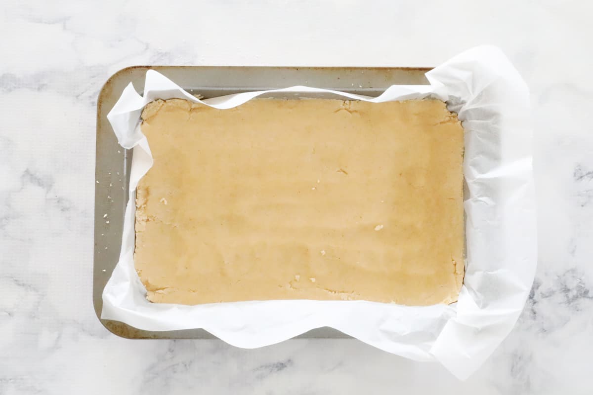 The base ingredients pressed into a slice tray and smoothed on top.