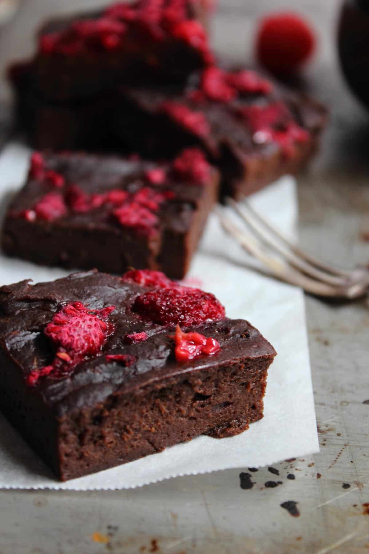 a chocolate raspberry brownie on a tray with a fork.