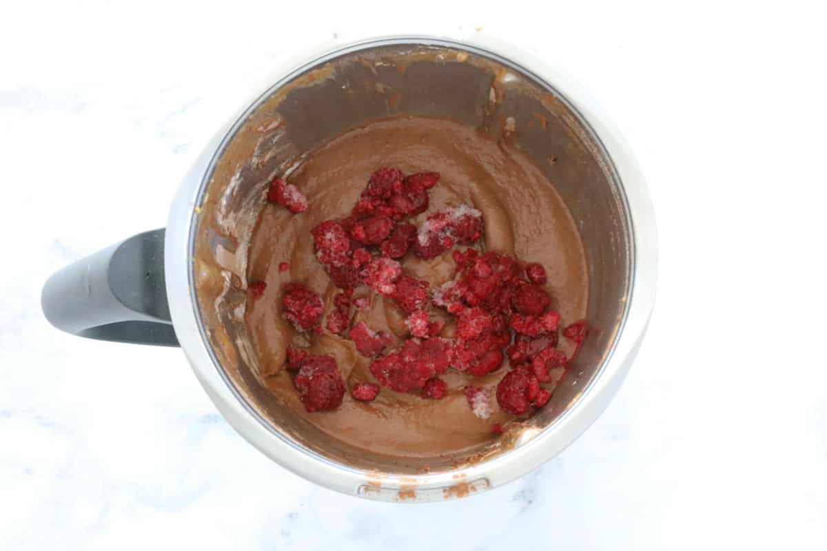 raspberries in brownie batter, in a Thermomix bowl.