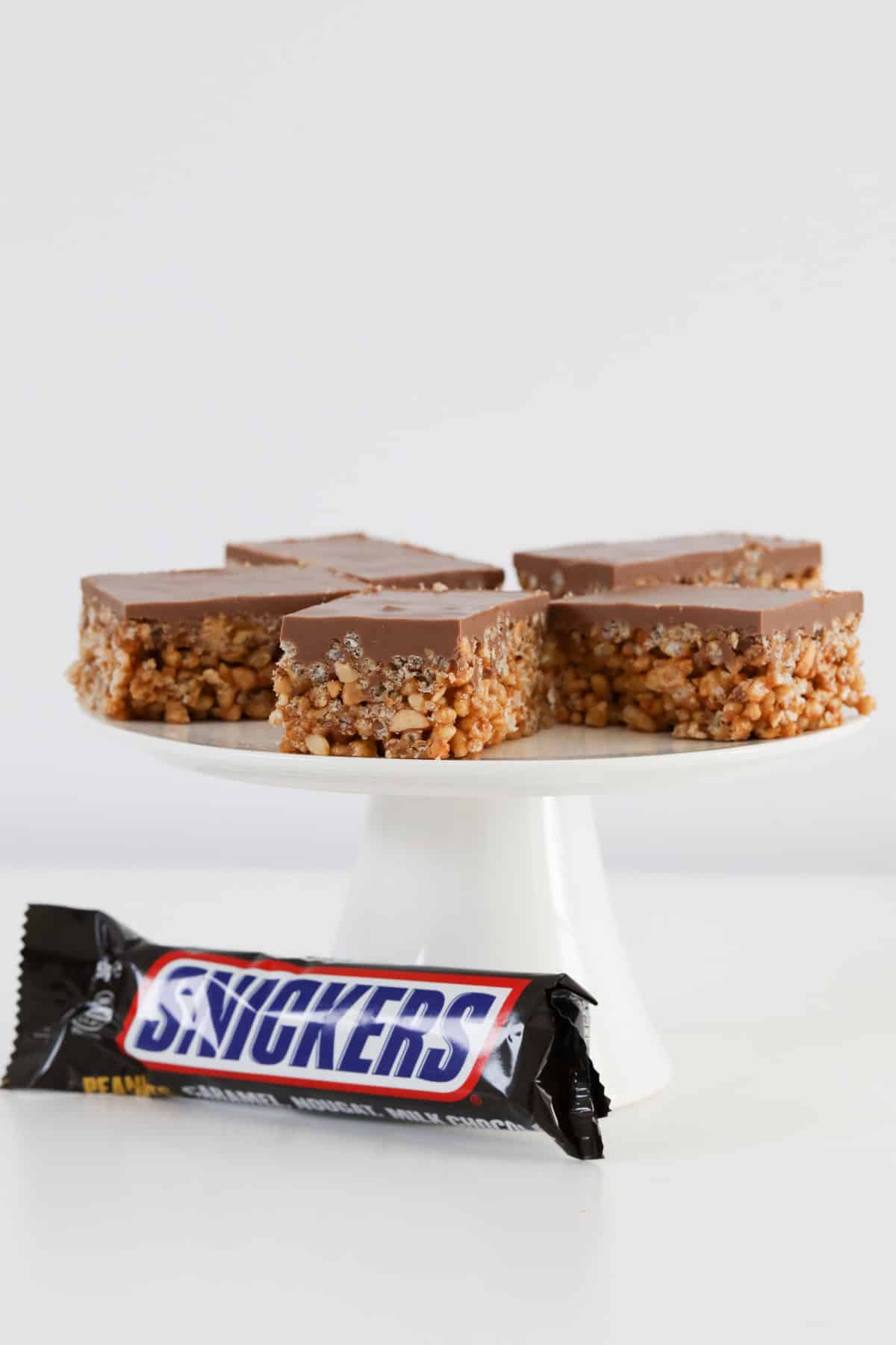 pieces of snickers slice arranged on a white stand.