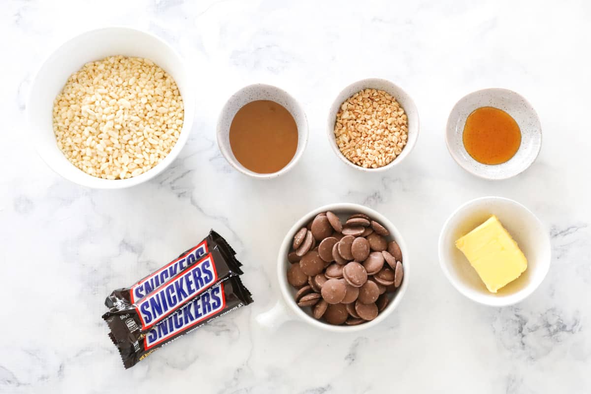 all ingredients for snickers slice, laid out on a table.