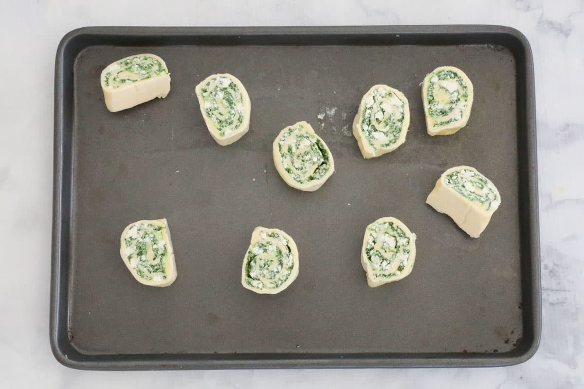 Pastry pinwheels arranged on a baking tray.