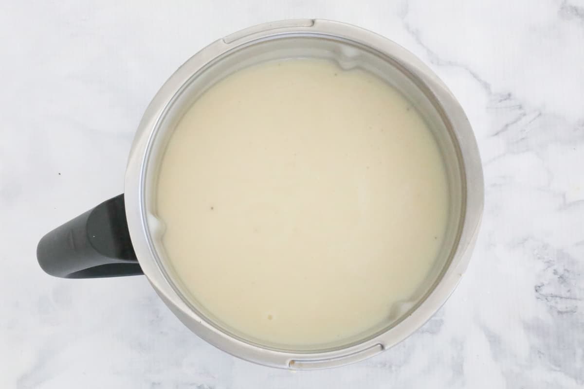 An overhead shot of thick and creamy pureed Cauliflower Soup in a Thermomix bowl