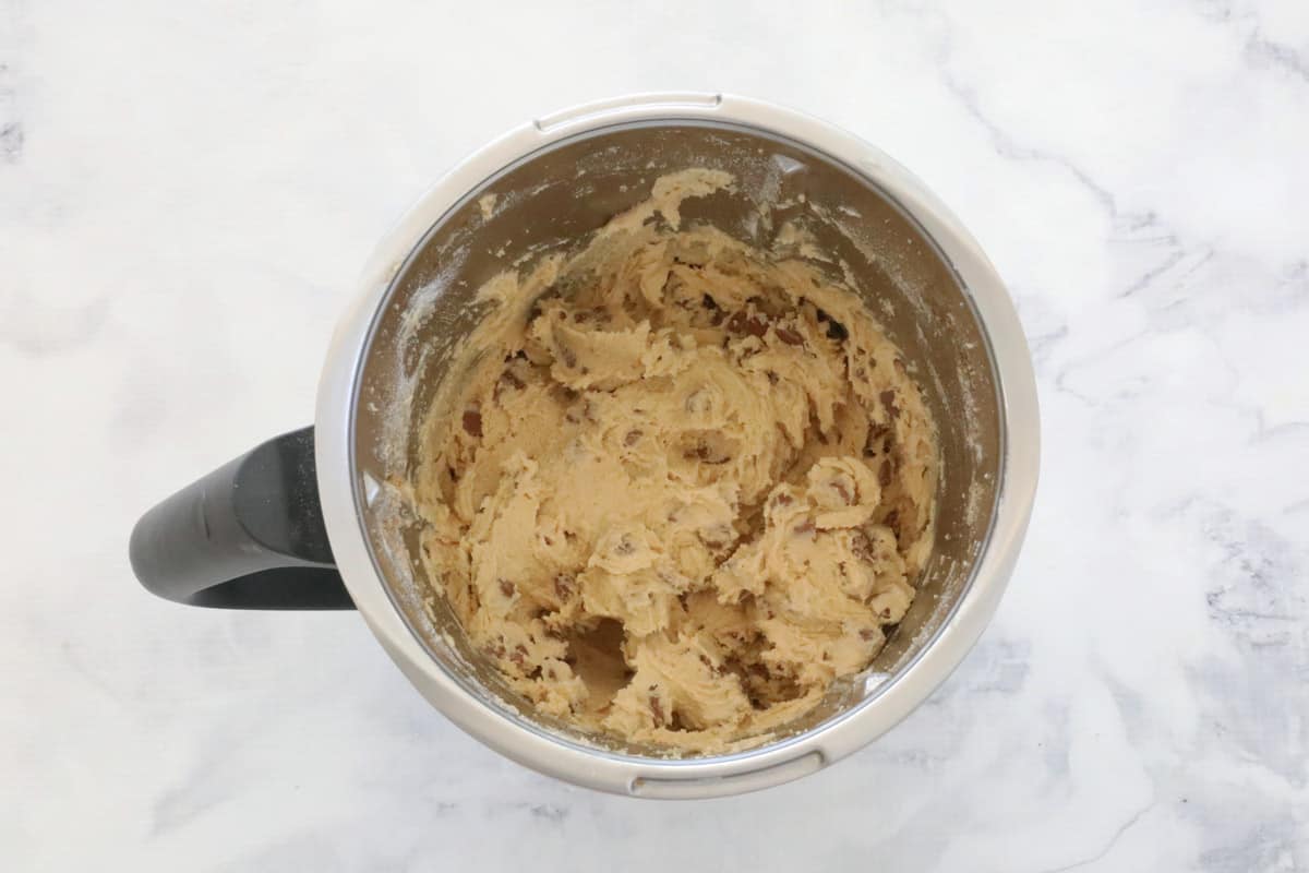 Chocolate chip mixed through cookie mixture in a Thermomix.