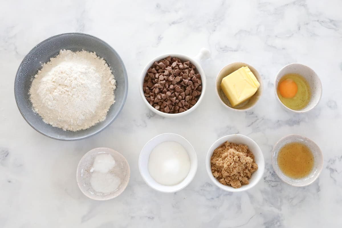 The ingredients for chocolate chip cookies in individual bowls.