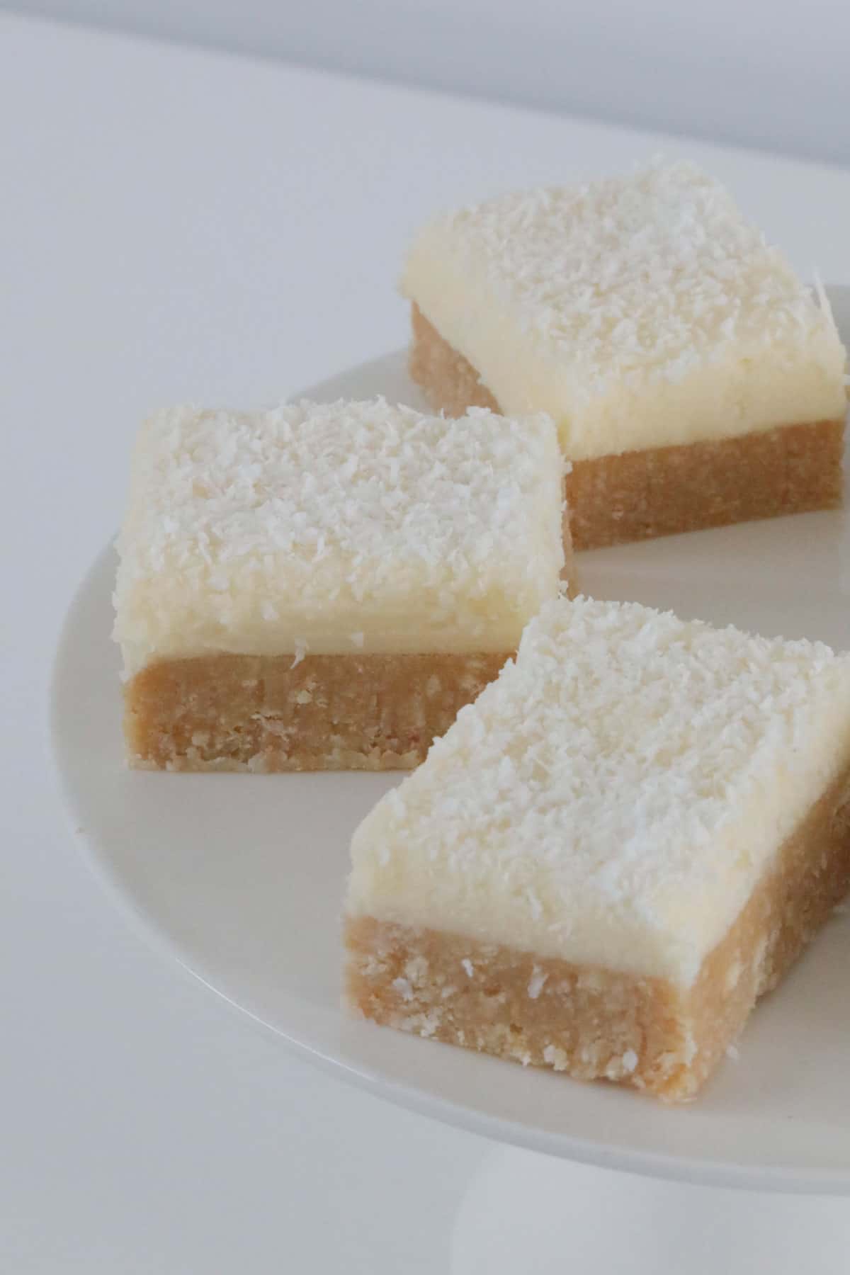 Pieces of no-bake lemon slice with frosting.