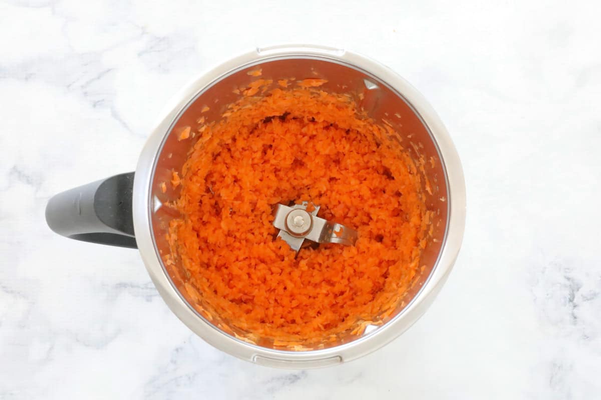 Grated carrot in a Thermomix bowl.