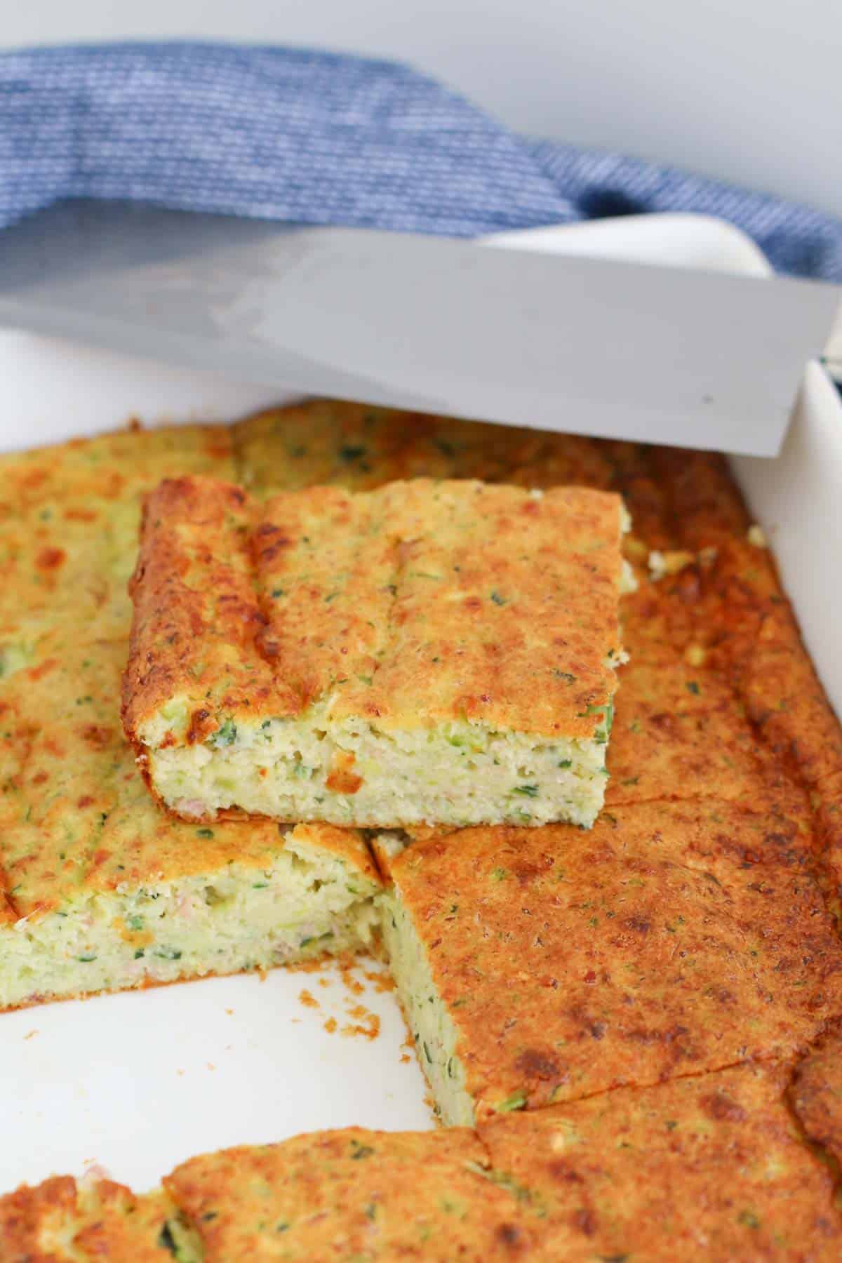 A square of zucchini slice in a baking tray.