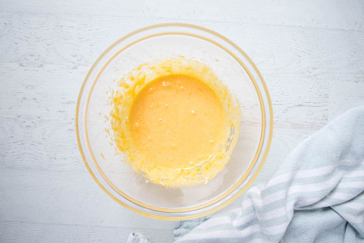 beaten egg yolks in a glass bowl
